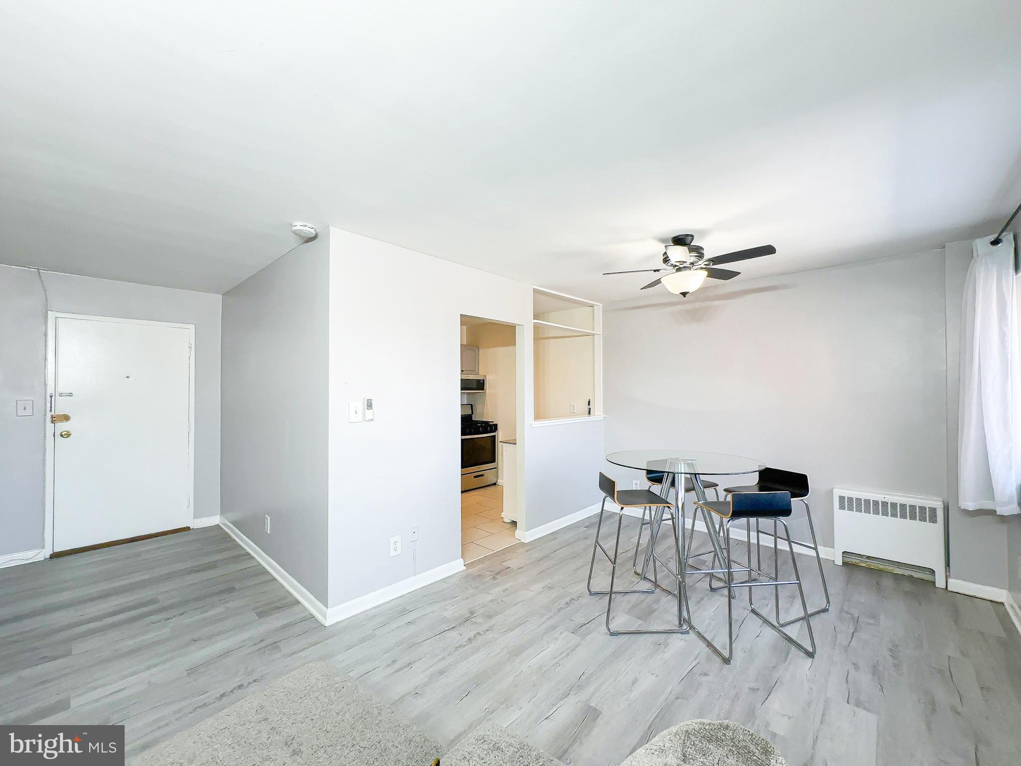 614 Sligo Avenue, Unit 405 Silver Spring, MD 20910 - Photo 7 of 31 a view of a dining room with furniture and wooden floor