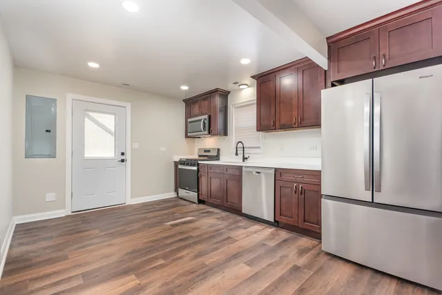 a kitchen with a refrigerator a sink and cabinets