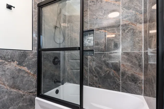 a bathroom with a glass shower door