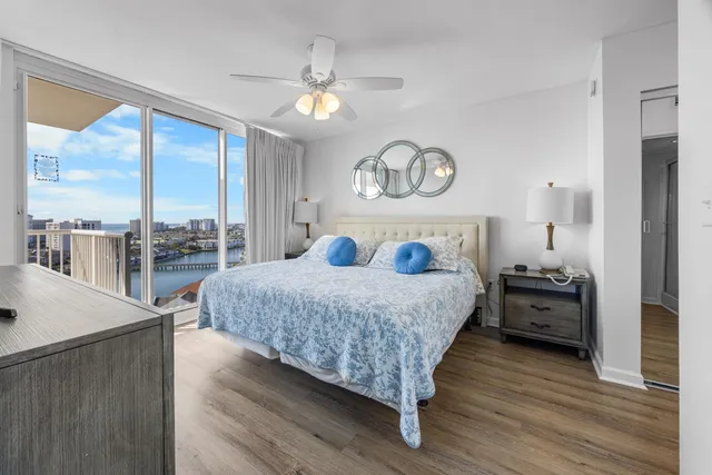 a bedroom with a large bed and a large window