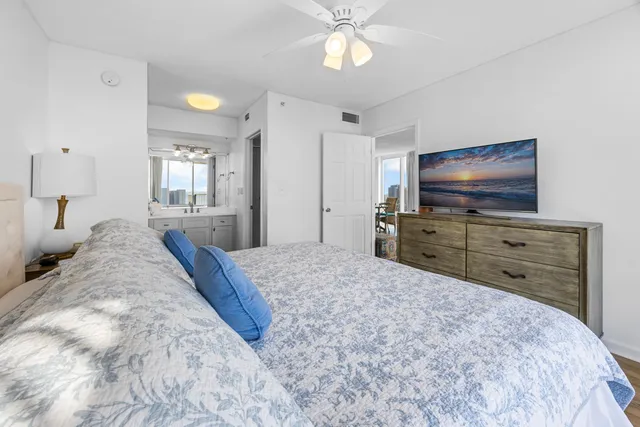 a bedroom with a bed and flat screen tv