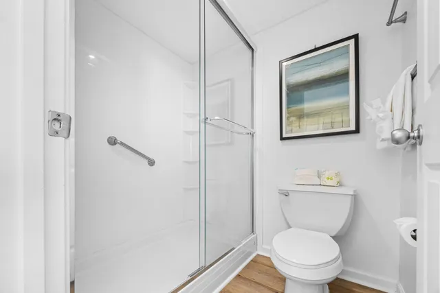 a white toilet sitting next to a bathroom sink