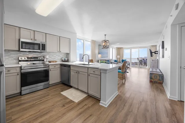 a kitchen with sink a microwave and cabinets