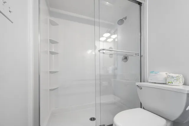 a bathroom with a toilet and a shower