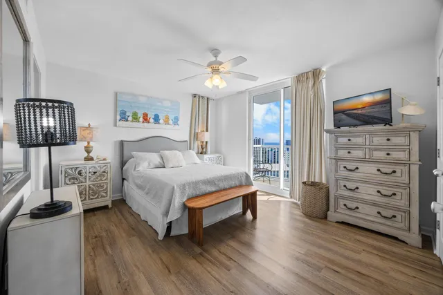 a spacious bedroom with a bed and wooden floor