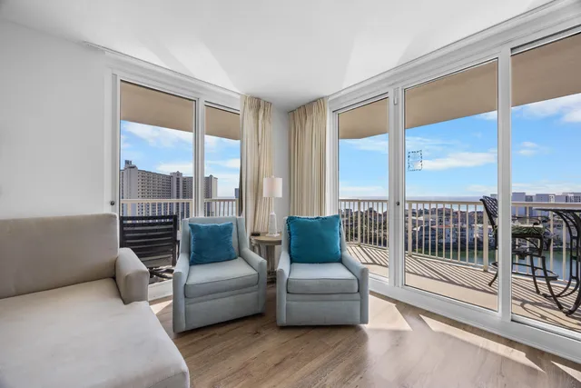a living room with furniture and a floor to ceiling window
