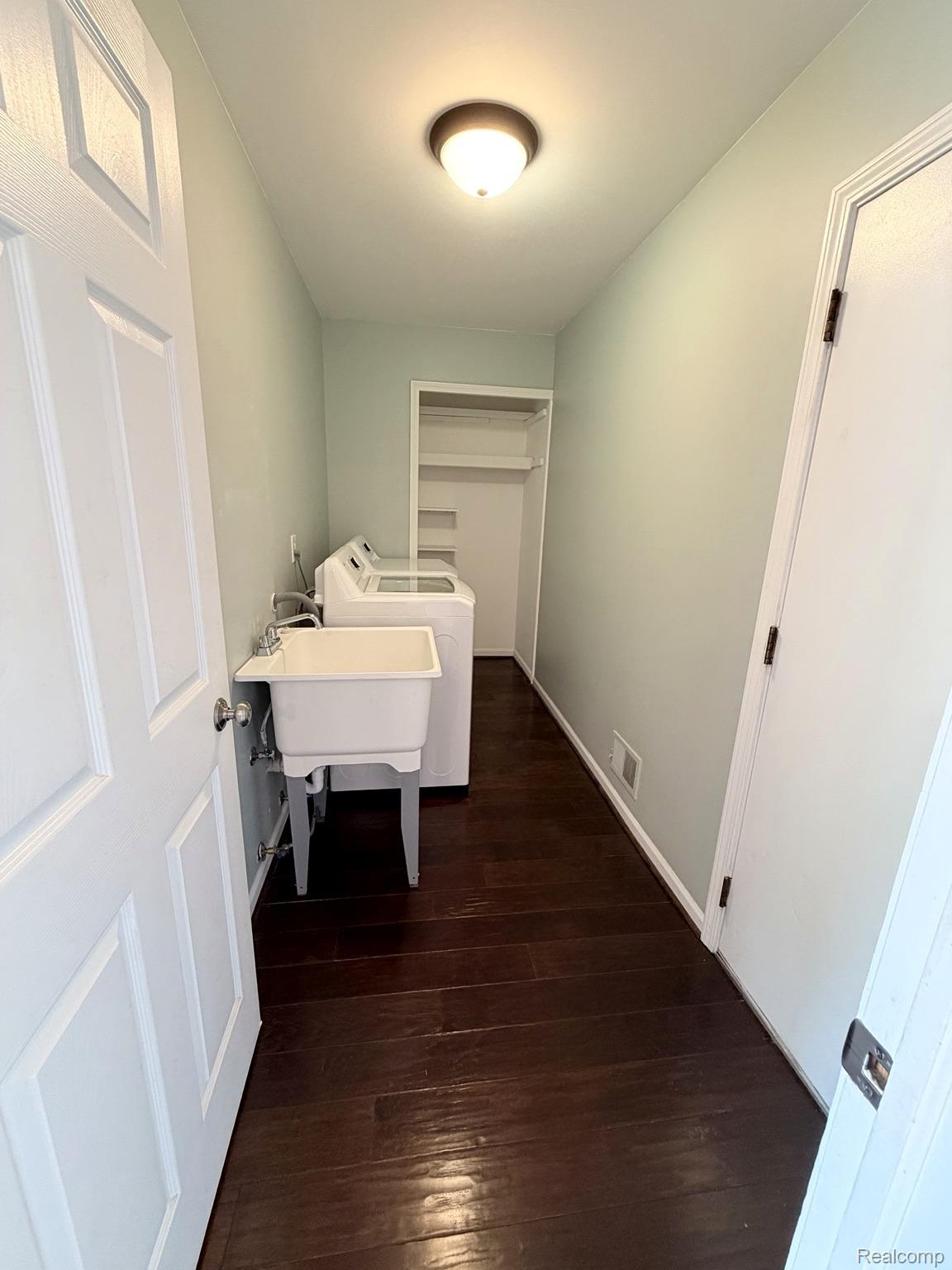 2070 Winchester Road Rochester, MI 48307 - Photo 14 of 34 Wood-finish flooring, utility sink, overhead lighting, and built-in shelving