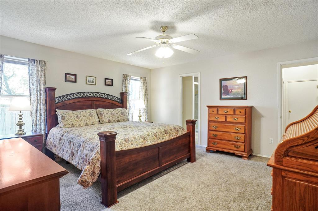 1116 Shadow Ridge Drive Azle, TX 76020 - Photo 14 of 27 a bedroom with a bed and a chandelier