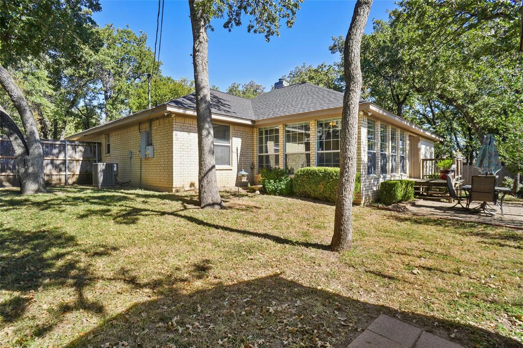 1116 Shadow Ridge Drive Azle, TX 76020 - Photo 24 of 27 a view of a white house with a large tree and yard