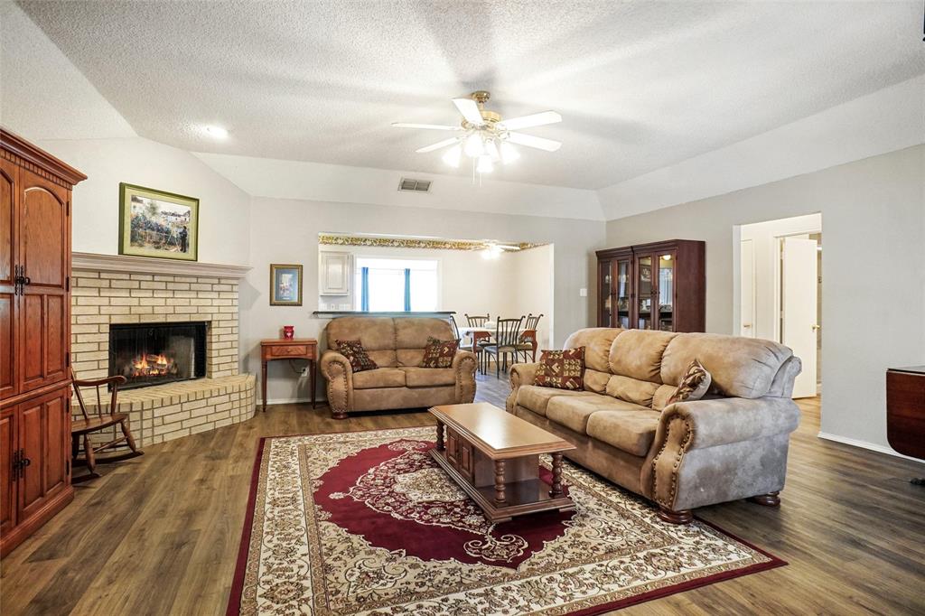 1116 Shadow Ridge Drive Azle, TX 76020 - Photo 4 of 27 a living room with furniture and a fireplace