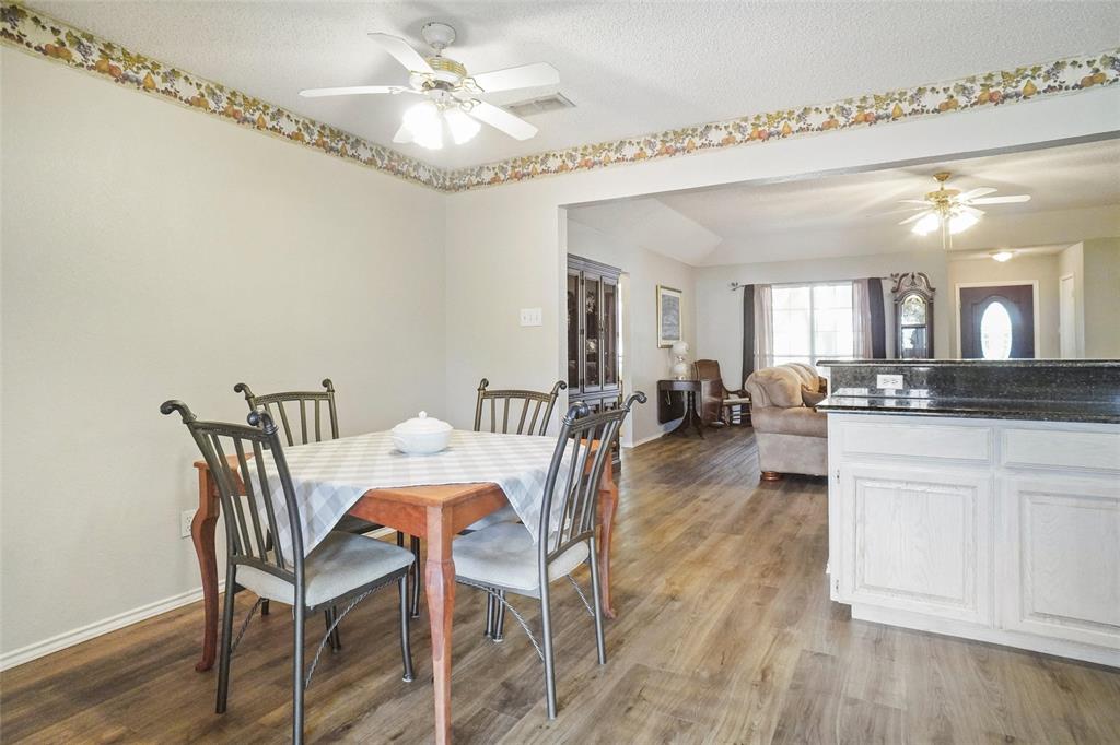 1116 Shadow Ridge Drive Azle, TX 76020 - Photo 7 of 27 a view of a dining room with furniture and wooden floor