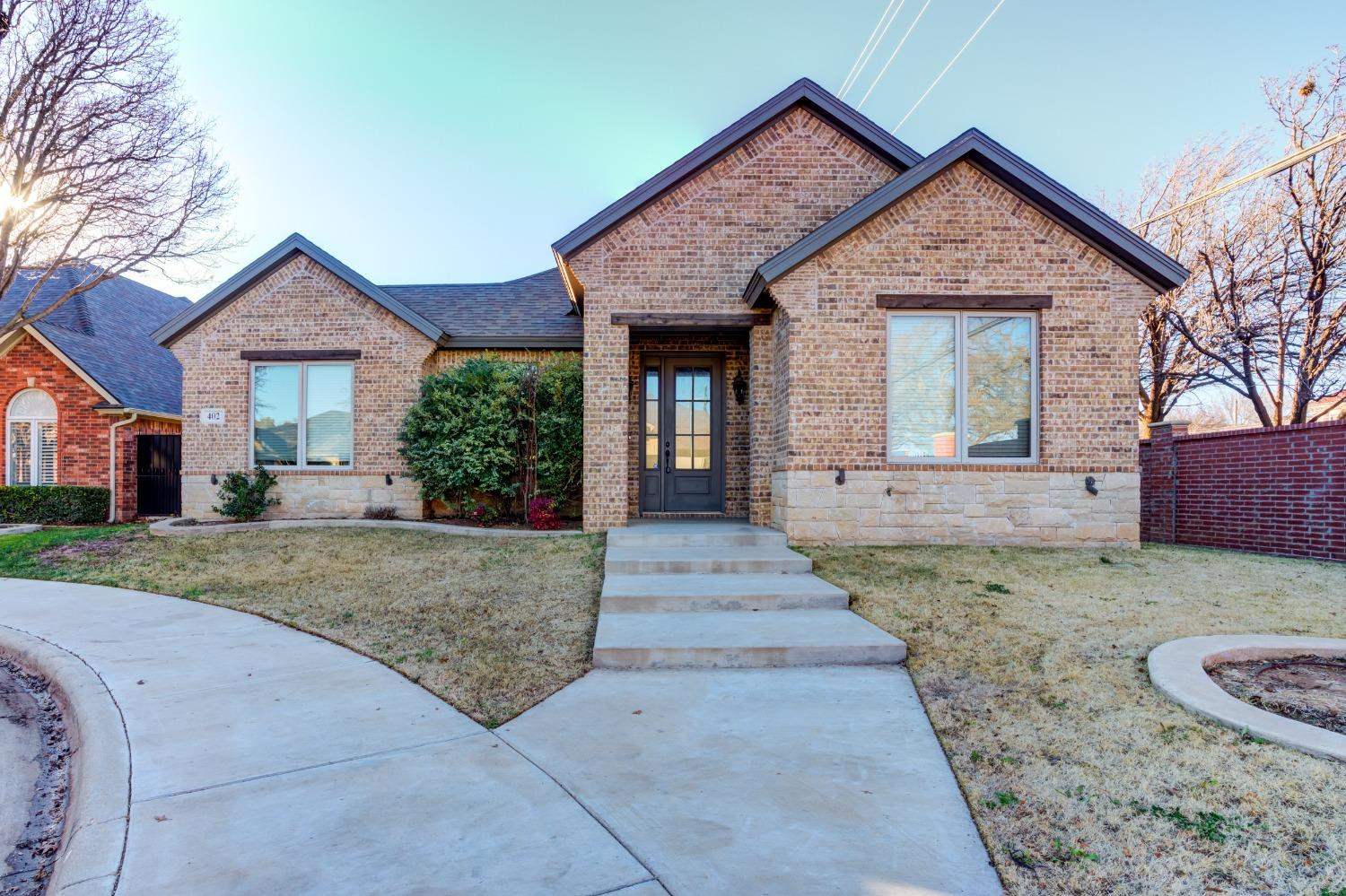 402 Topeka Avenue Lubbock, TX 79416 - Photo 1 of 41 a front view of a house with a yard and garage