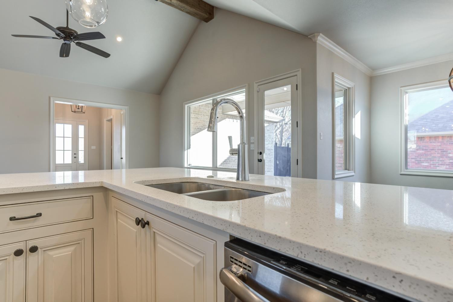 402 Topeka Avenue Lubbock, TX 79416 - Photo 15 of 41 a kitchen with a sink and large windows