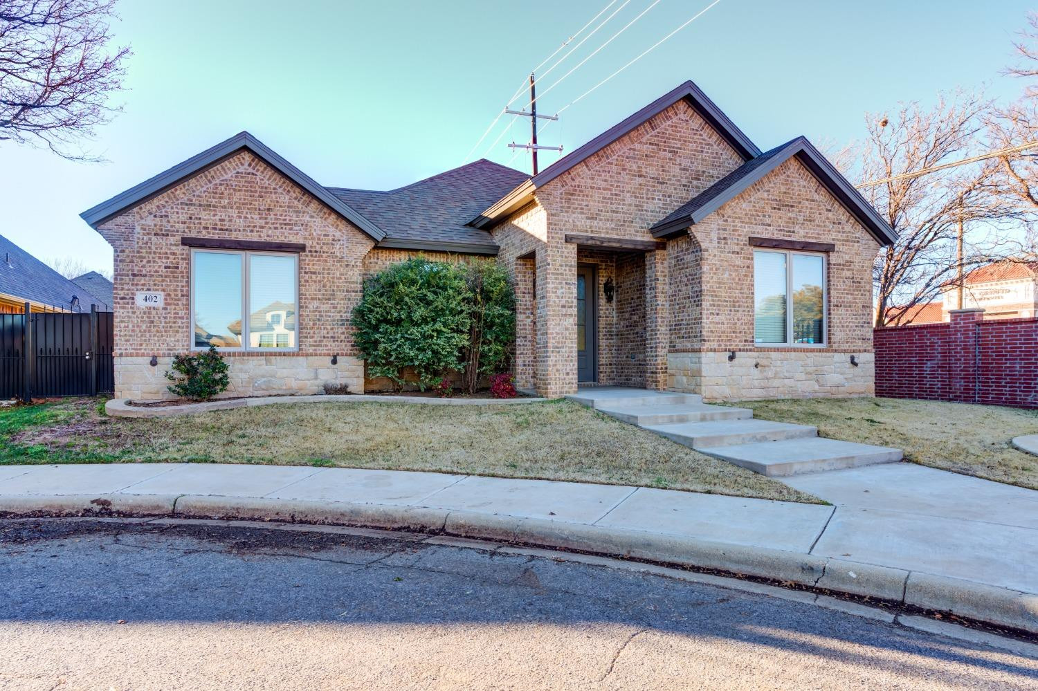 402 Topeka Avenue Lubbock, TX 79416 - Photo 2 of 41 a front view of a house with a yard and garage