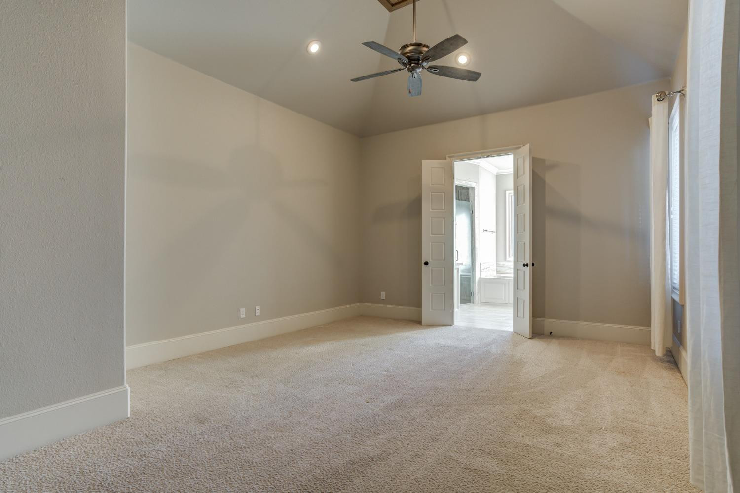 402 Topeka Avenue Lubbock, TX 79416 - Photo 39 of 41 an empty room with chandelier fan and windows