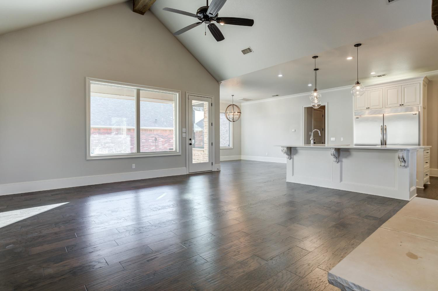 402 Topeka Avenue Lubbock, TX 79416 - Photo 9 of 41 a view of an empty room with wooden floor and a window