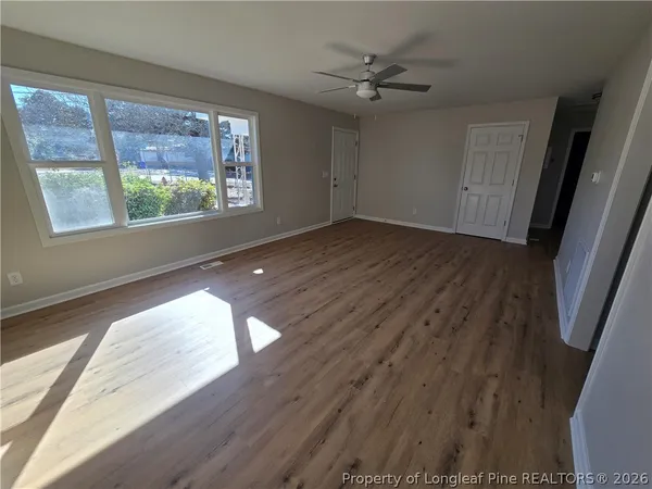 wooden floor in an empty room with a window