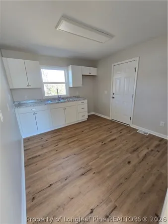 a view of a kitchen with wooden floor