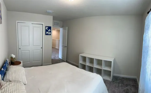 a bedroom with a bed and a window