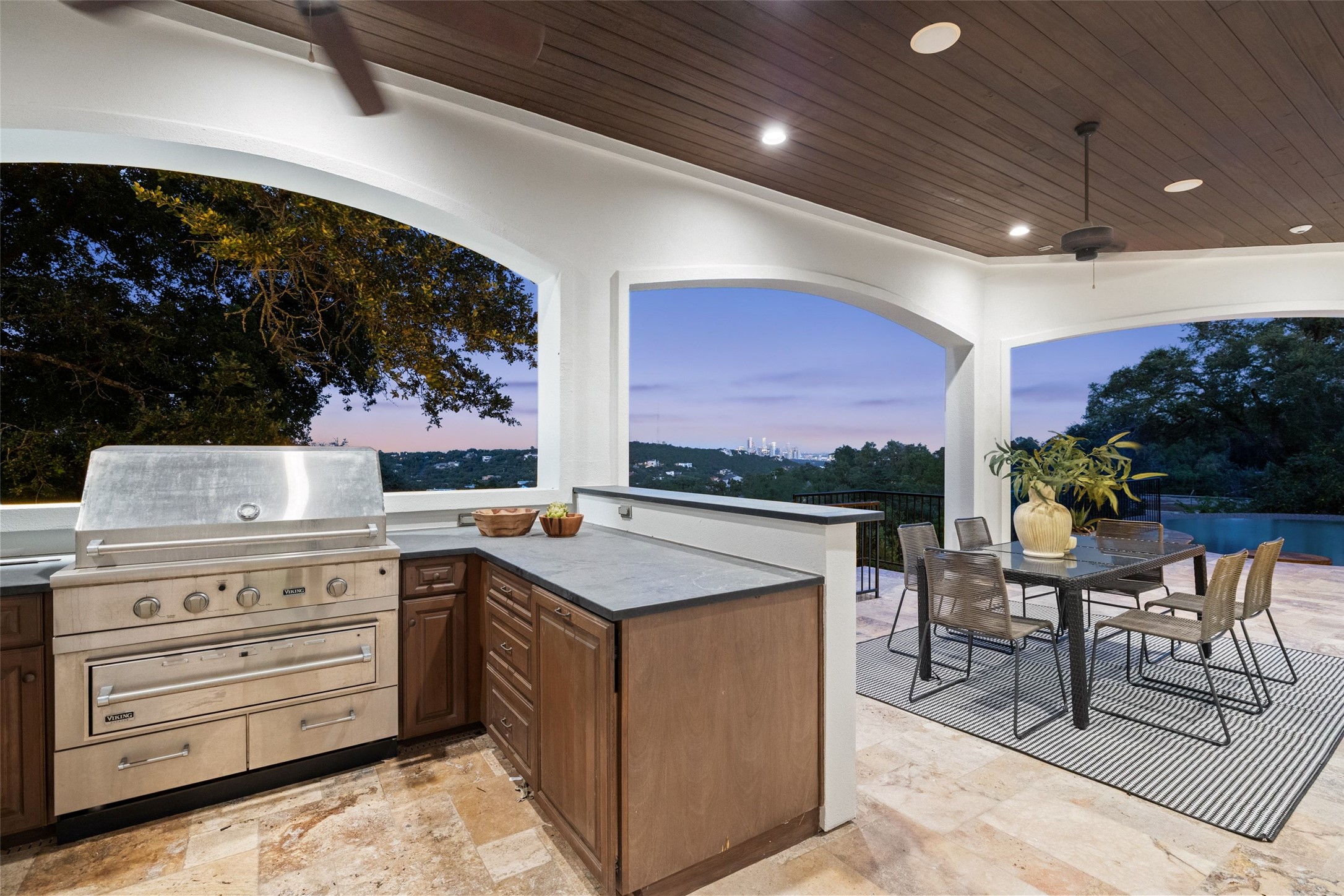 1414 The High Road Austin, TX 78746 - Photo 35 of 40 An outdoor kitchen and dining area with a sweeping city and landscape panorama.