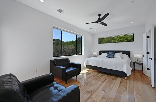 a bedroom with a bed and wooden floor