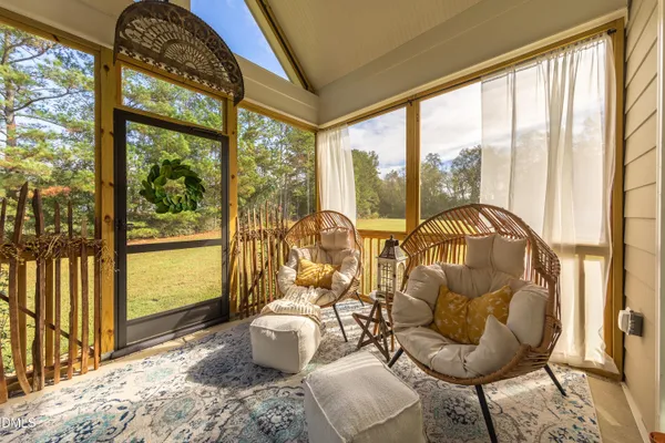 a living room with furniture and a floor to ceiling window