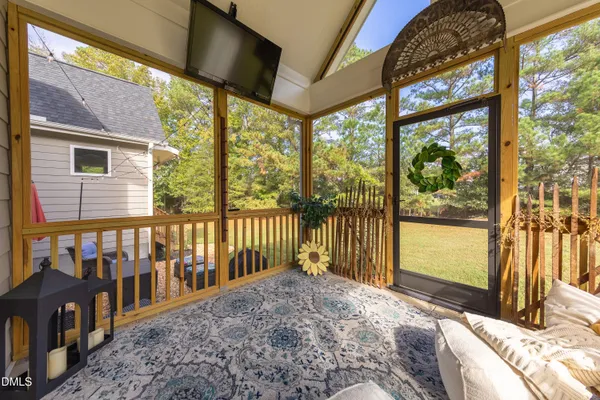 a bedroom with furniture and a large window