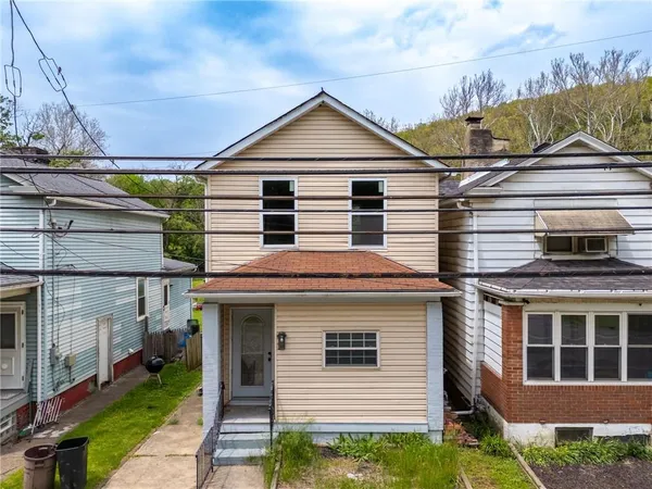 a front view of a house with a yard