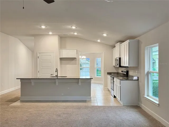 a kitchen with stainless steel appliances granite countertop a stove and a sink