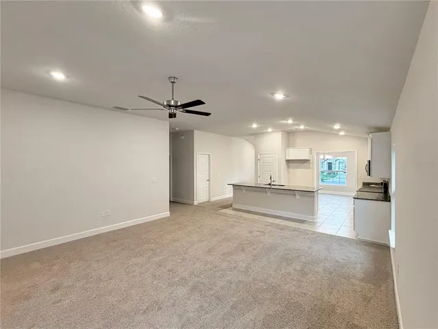 a view of a kitchen with a sink and a refrigerator