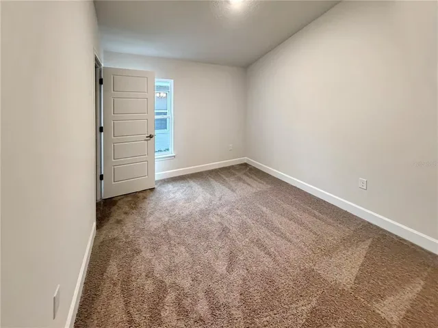 an empty room with closet area
