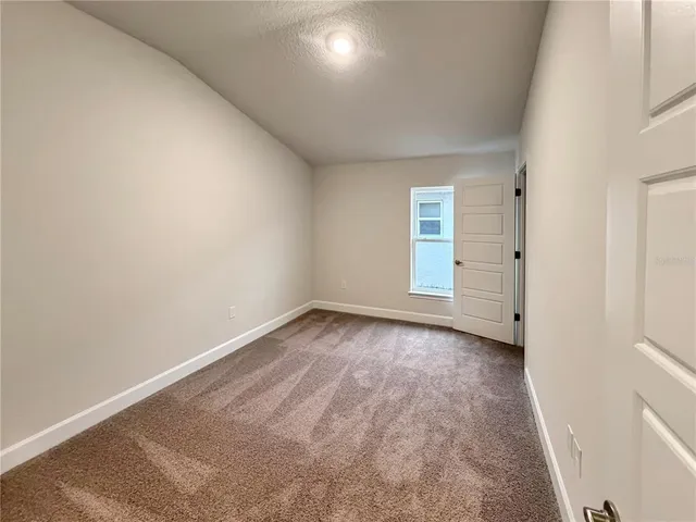 a bathroom with a granite countertop double vanity sink and mirror