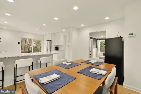 a large kitchen with a table and chairs in it