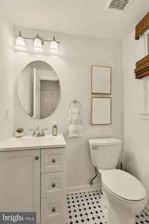 a bathroom with a toilet a sink and a mirror