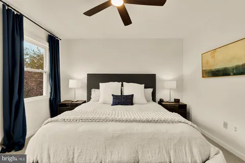 a bedroom with a bed and window