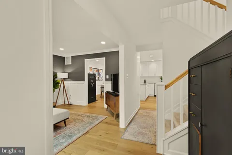 a view of a hallway with white cabinets and entryway