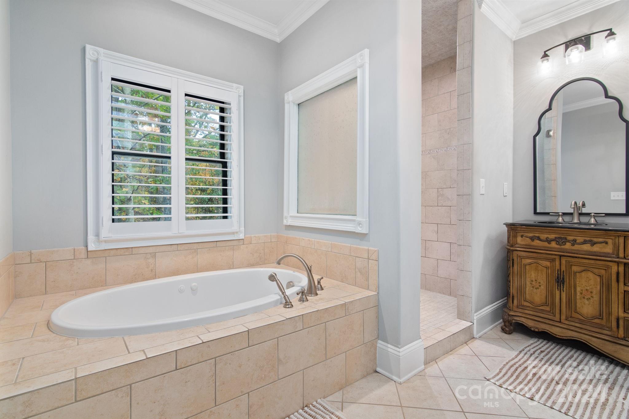 2049 Rocky Stream Road York, SC 29745 - Photo 16 of 47 a bathroom with a tub sink and mirror