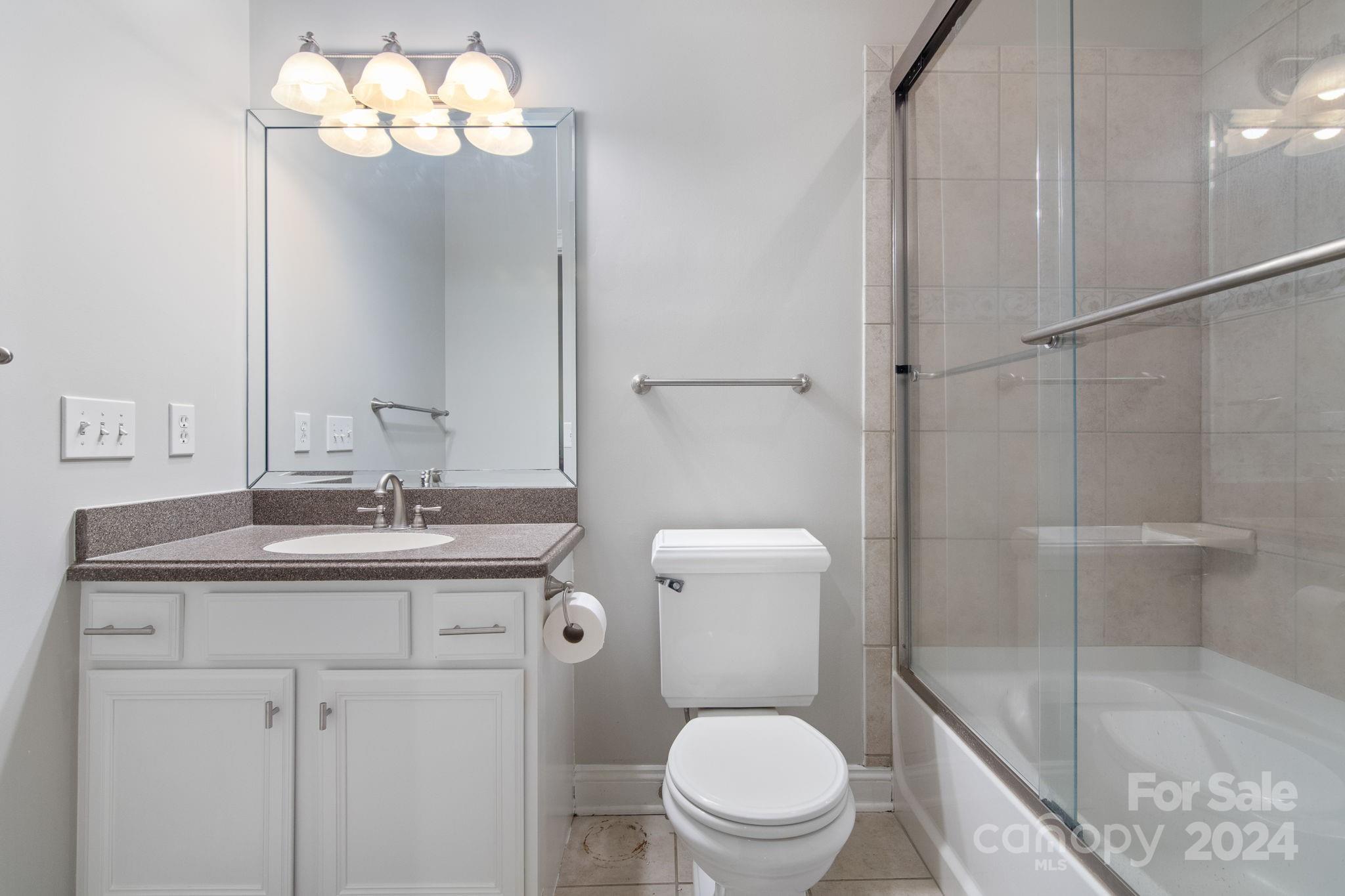 2049 Rocky Stream Road York, SC 29745 - Photo 18 of 47 a bathroom with a granite countertop toilet sink and shower