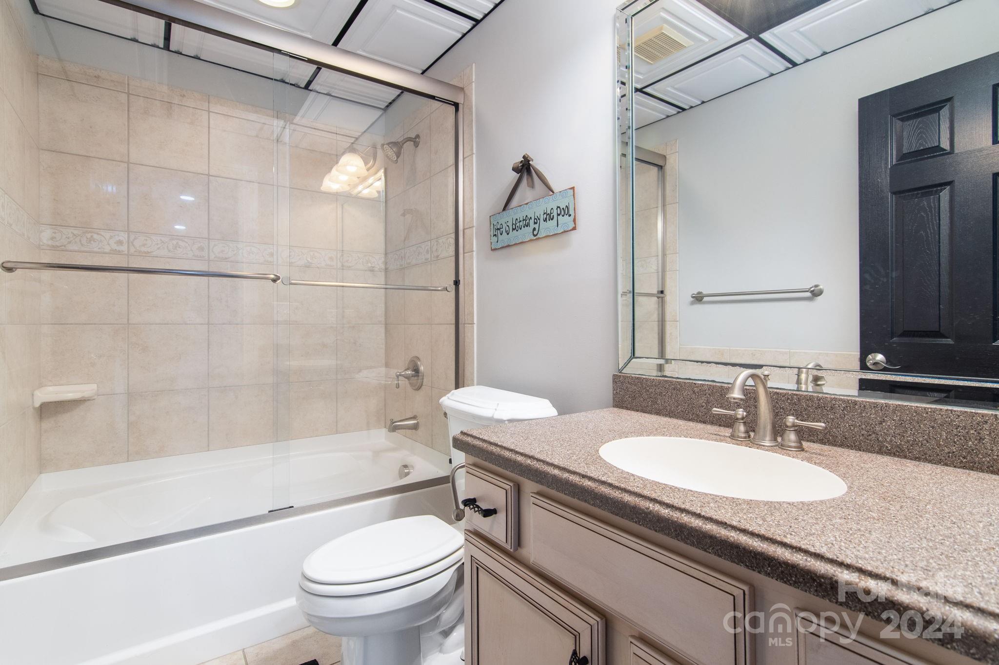 2049 Rocky Stream Road York, SC 29745 - Photo 24 of 47 a bathroom with a granite countertop sink toilet and shower