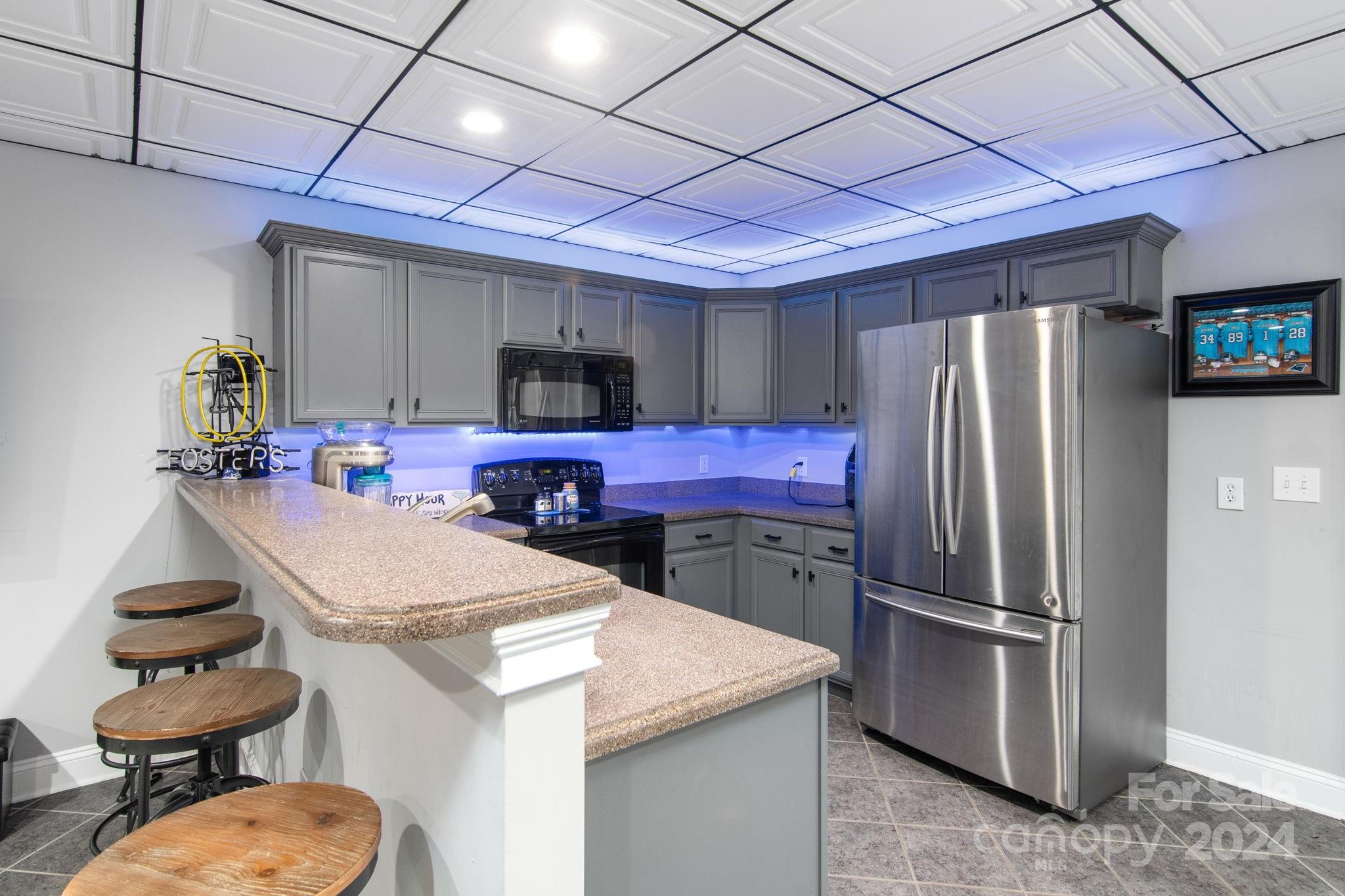 2049 Rocky Stream Road York, SC 29745 - Photo 28 of 47 a kitchen with sink a refrigerator and chairs