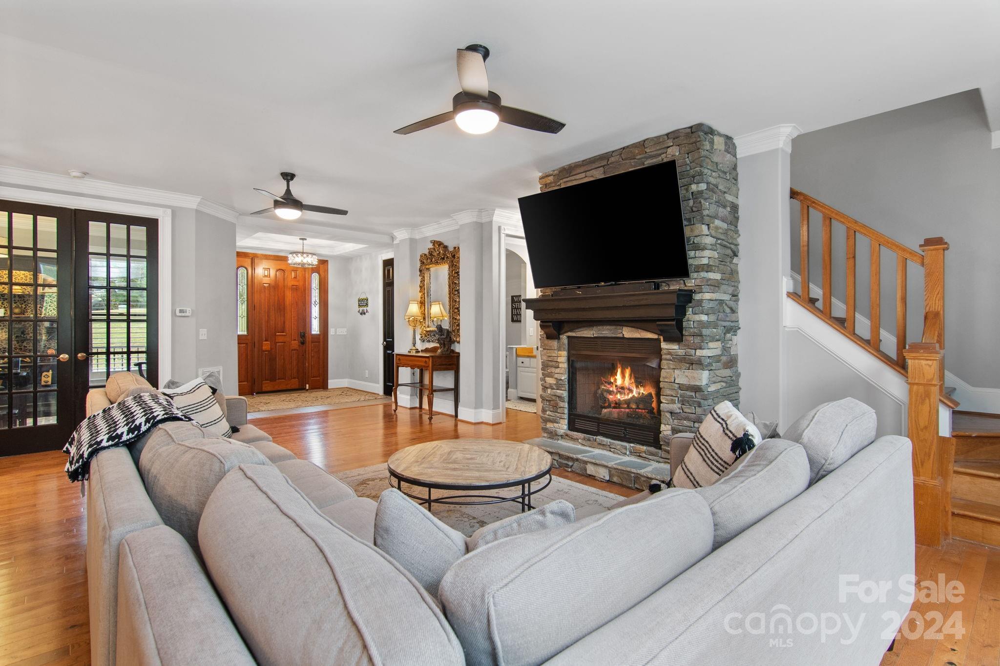 2049 Rocky Stream Road York, SC 29745 - Photo 5 of 47 a living room with furniture a flat screen tv and a fireplace