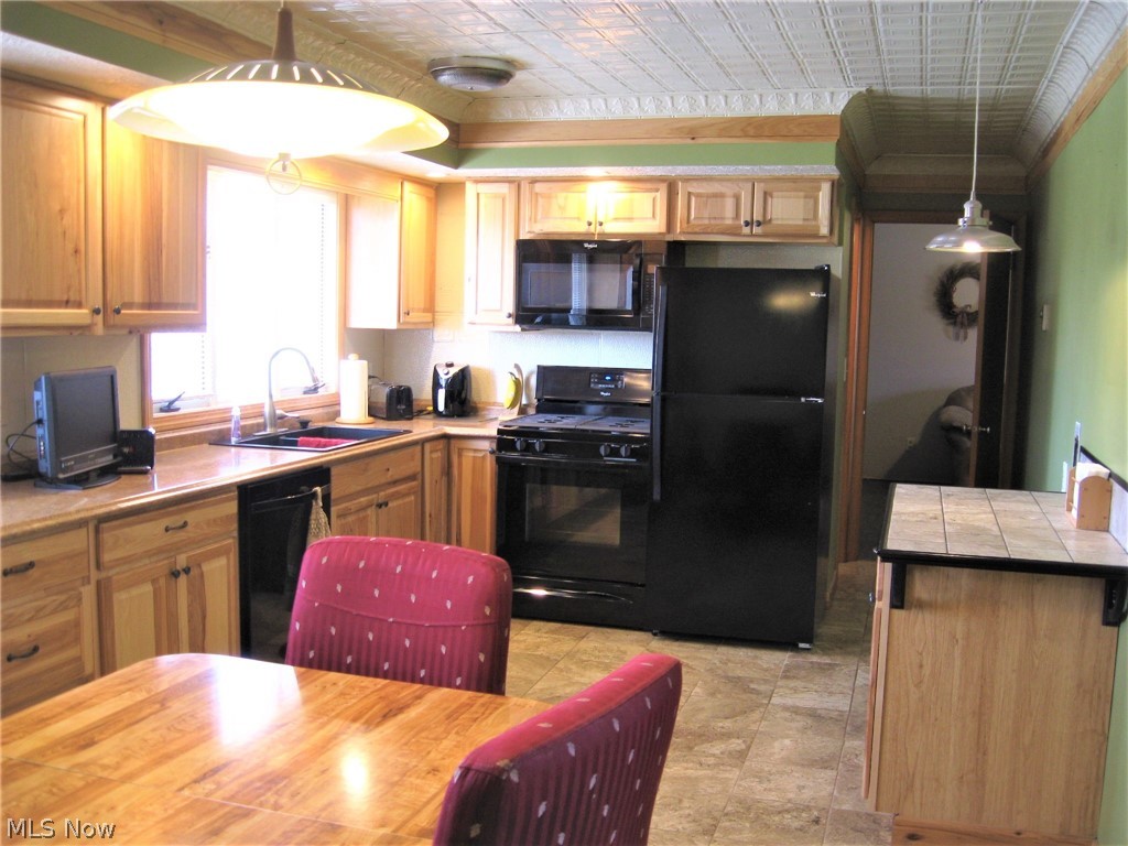 9108 Spencer Road Homerville, OH 44235 - Photo 5 of 14 The remodeled Hickory kitchen features a tin ceiling and ceramic floor. All kitchen appliances stay.