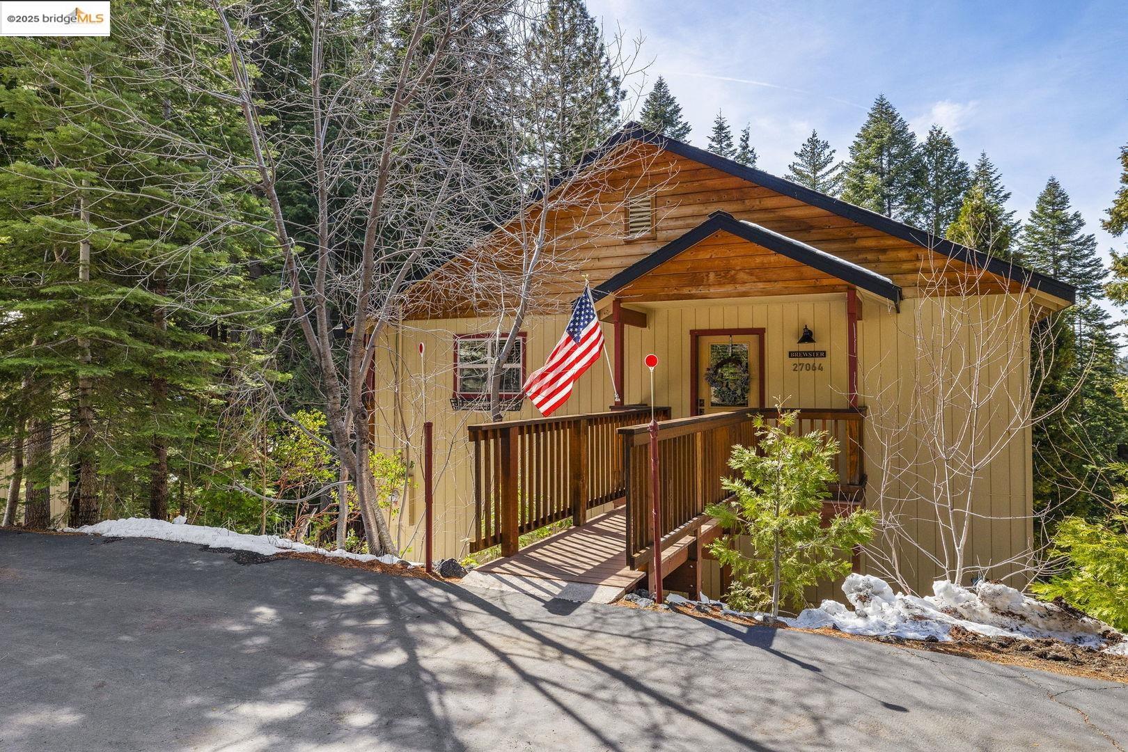 27064 Summerhill Drive Pinecrest, CA 95364 - Photo 1 of 1 a front view of a house with a yard