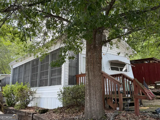 a view of a house with a tree in front of it
