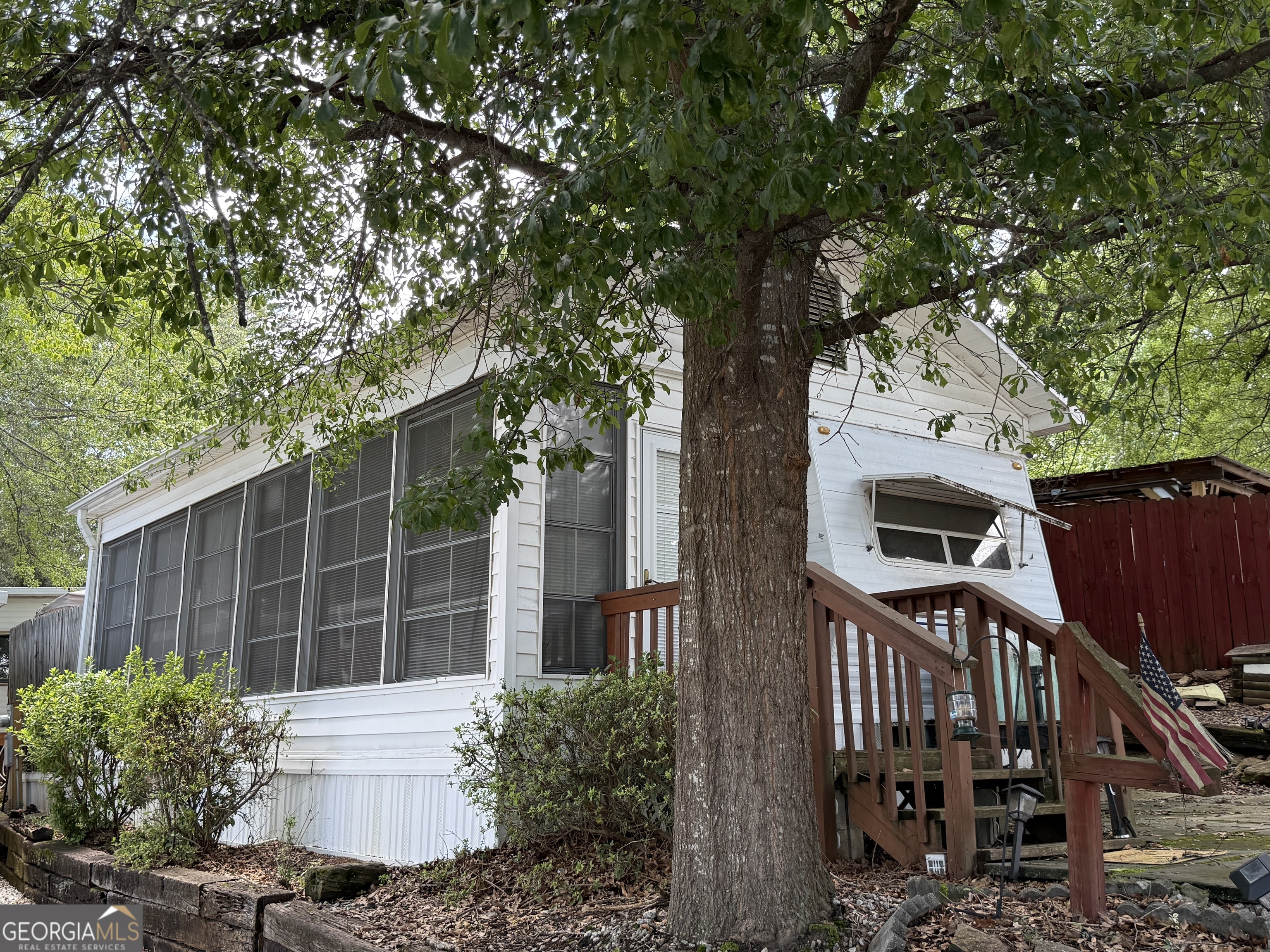 a view of a house with a tree in front of it