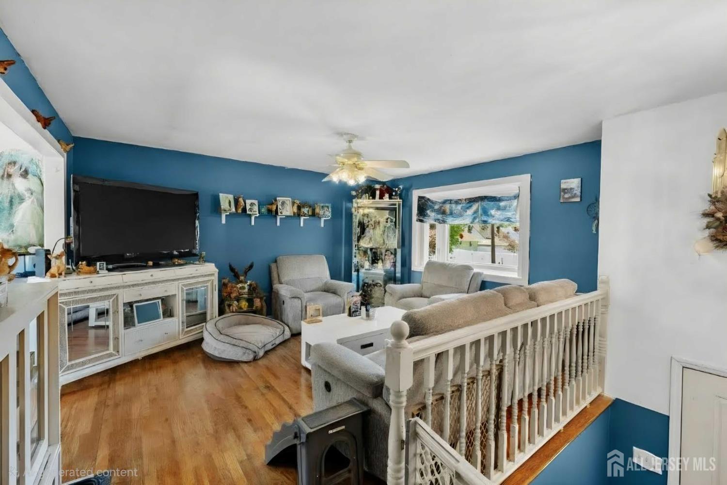 245 4th Street Dunellen, NJ 08812 - Photo 5 of 27 a living room with furniture and a flat screen tv