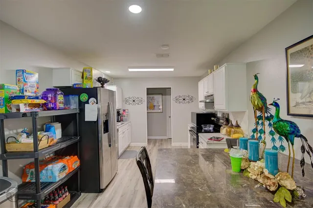 a view of a livingroom with furniture and a flat screen tv