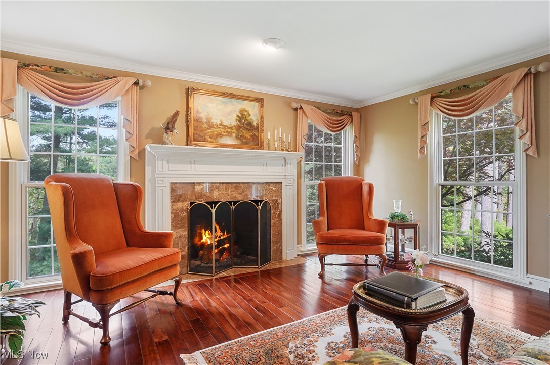 4432 Ira Road Akron, OH 44333 - Photo 7 of 50 Sitting room with crown molding, hardwood / wood-style floors, and a premium fireplace
