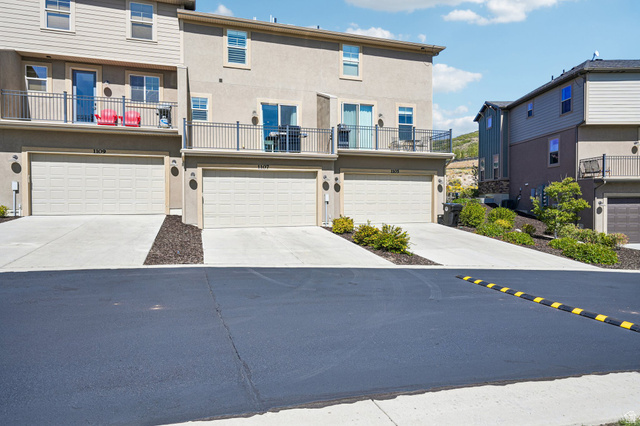 1107 West Wasatch Springs Road, Unit M3 Heber City, UT 84036 - Photo 27 of 34 Multi-level townhome featuring a neutral stucco exterior, private balconies with metal railings, and attached garages