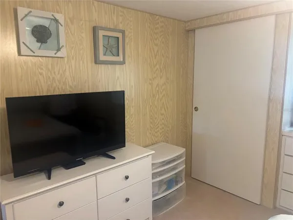 a room with a furniture and a flat screen tv